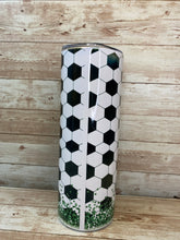 Load image into Gallery viewer, Tumbler with soccer ball pattern and green glitter grass.
